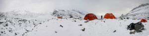 The picture shows the base camp over the Corner glacier. Red tents in the snow