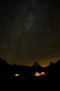the base camp during the night, with a sky full of bright stars