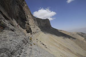 Rappel down on the cliff to finding a cave entrances in the mountain of Uzbekistan