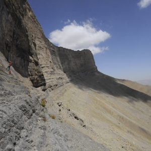 Rappel down on the cliff to finding a cave entrances in the mountain of Uzbekistan